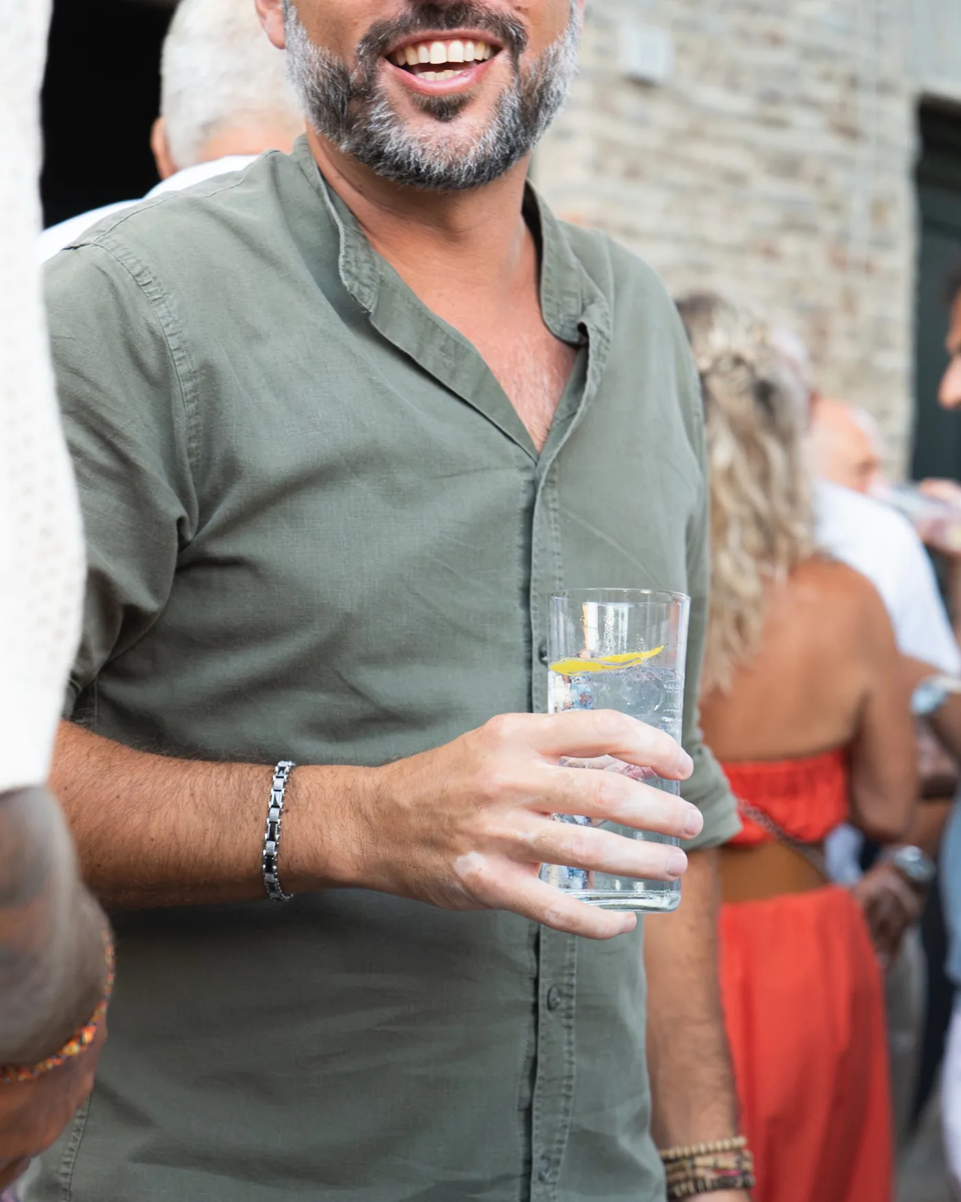 Una donna sorride con un calice di vino